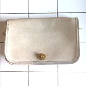 Coach bag in eggshell hue.